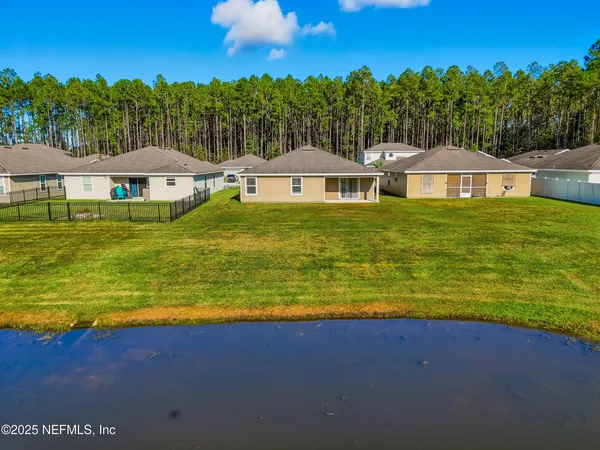 a view of an swimming pool with lawn chairs under an umbrella