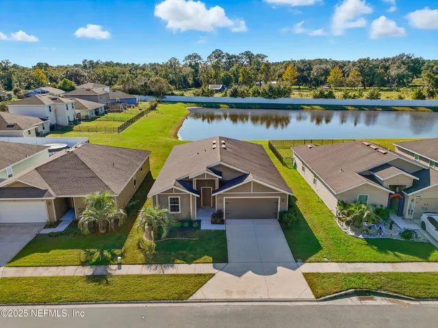 an aerial view of a house with a lake view