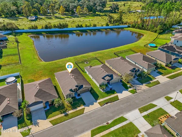an aerial view of a house with a lake view