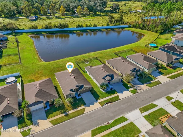 an aerial view of a house with a lake view