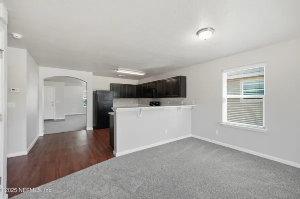 a view of a kitchen with wooden floor and a sink