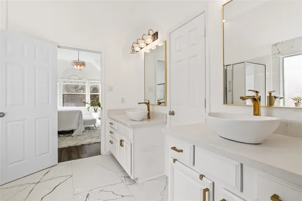 a spacious bathroom with a double vanity sink a mirror and a bathtub