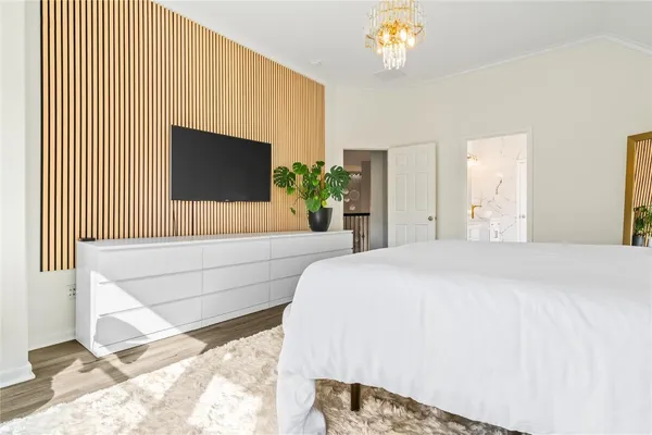 a bedroom with a bed and a flat screen tv