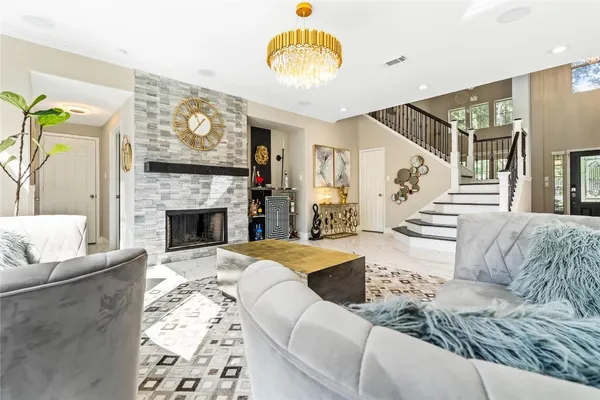 a living room with furniture and a fireplace
