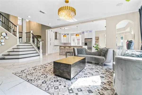 a living room with furniture and a chandelier