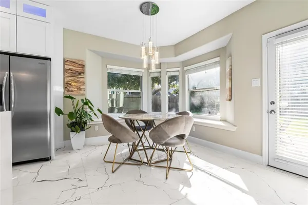 a dining room with furniture a chandelier and wooden floor