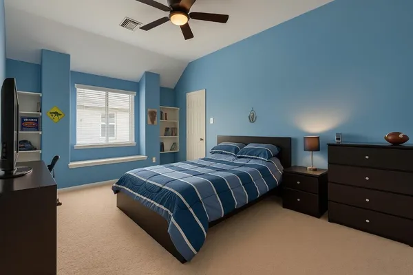 a spacious bedroom with a bed and a window