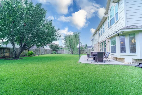 a view of a house with a yard and sitting area