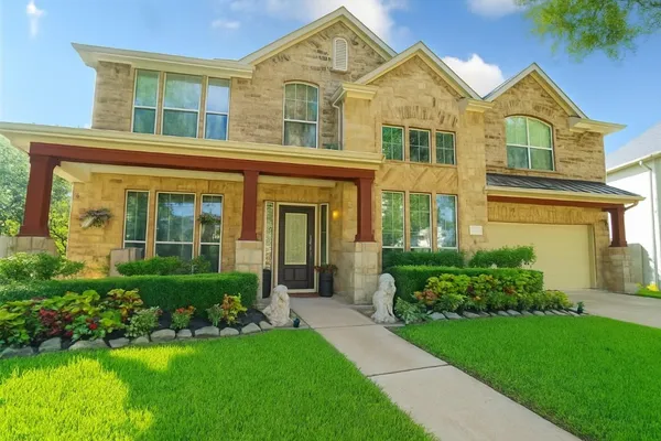 a front view of a house with a yard and porch
