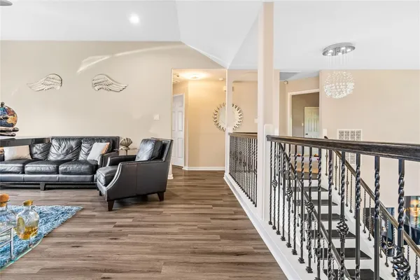 a balcony with furniture and wooden floor