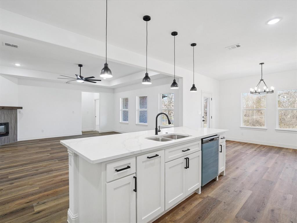 448 Rs County Road Alba, TX 75410 - Photo 33 of 34 a kitchen with a sink chandelier and wooden floor