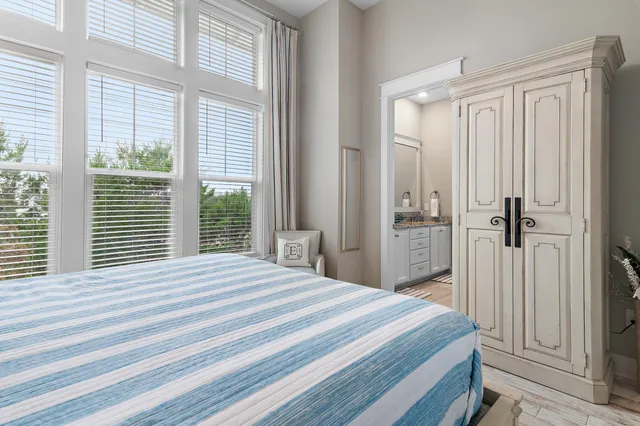 a bathroom with a granite countertop shower a sink and a window
