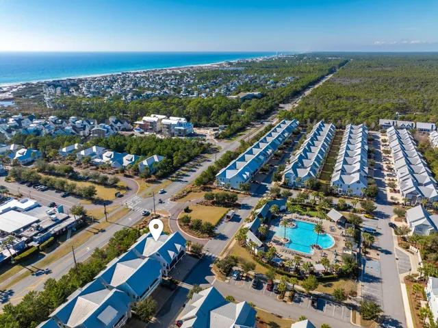 an aerial view of residential houses with outdoor space and street view