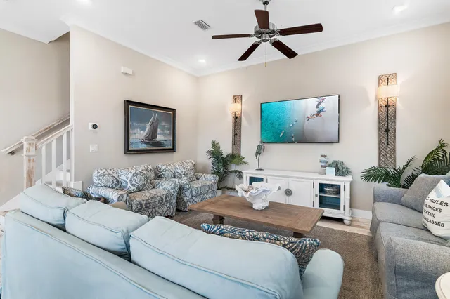 a living room with furniture a chandelier and a window