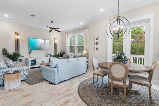 a living room with furniture a flat screen tv and a large window