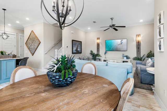 a living room with furniture a rug and kitchen view