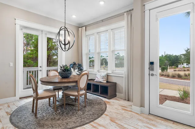 a dining room with furniture a window and wooden floor