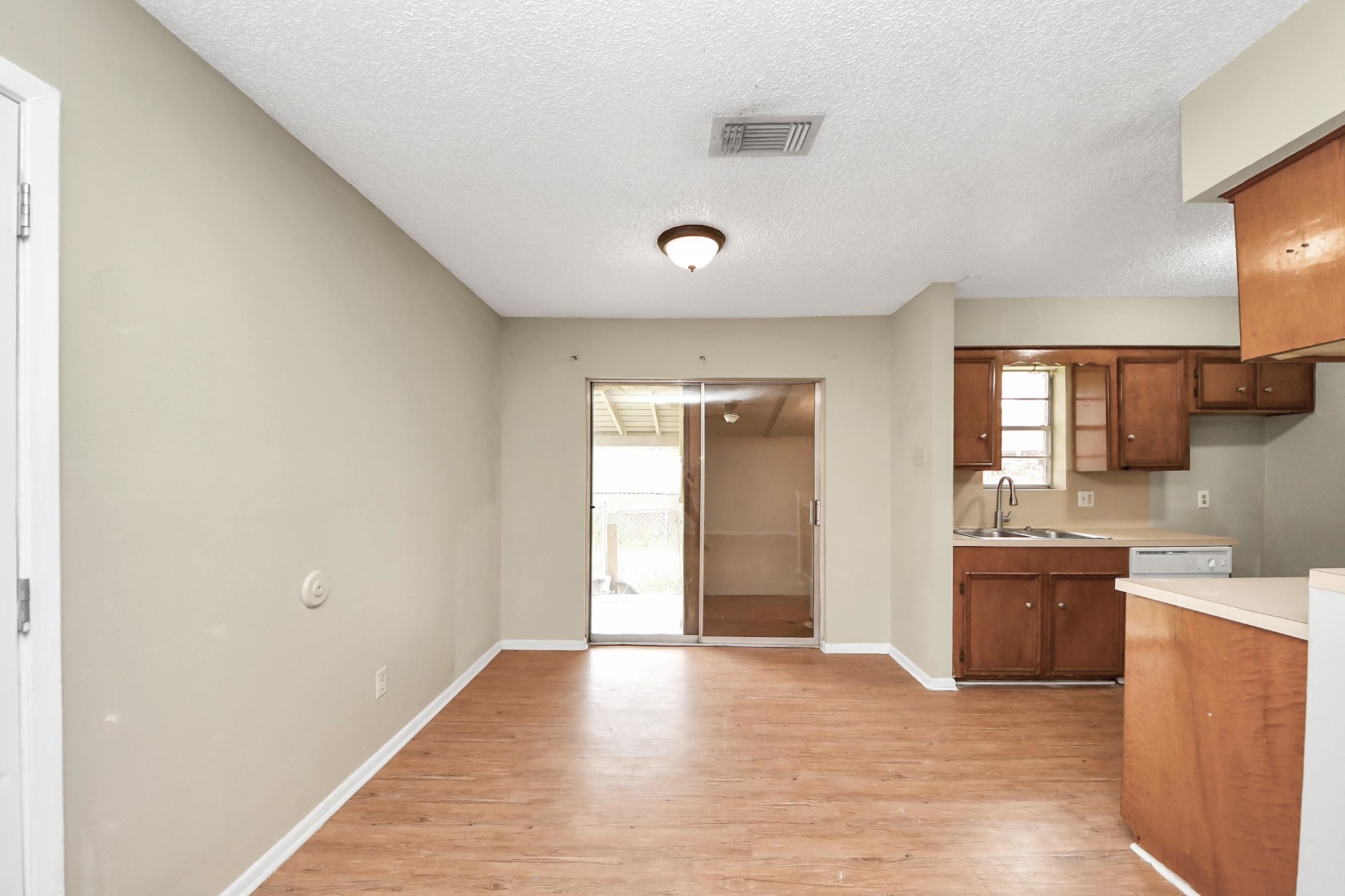 1006 Perry Street, Unit 100 Cleveland, TX 77327 - Photo 13 of 38 a view of a kitchen with a sink and cabinets