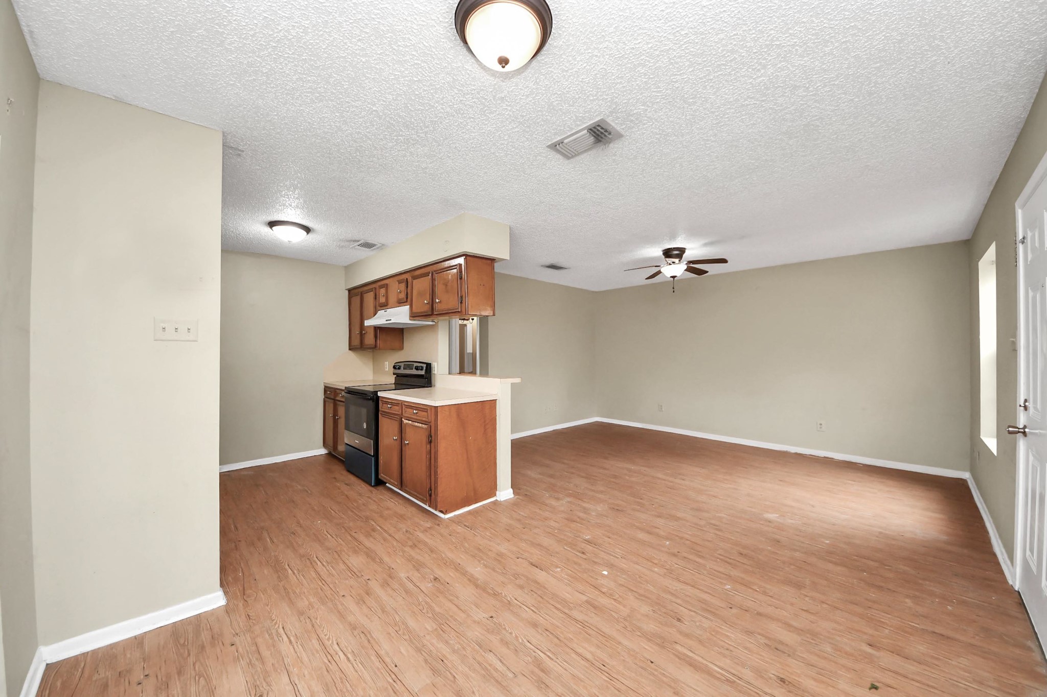 1006 Perry Street, Unit 100 Cleveland, TX 77327 - Photo 16 of 38 a view of a room with a cabinet and wooden floor