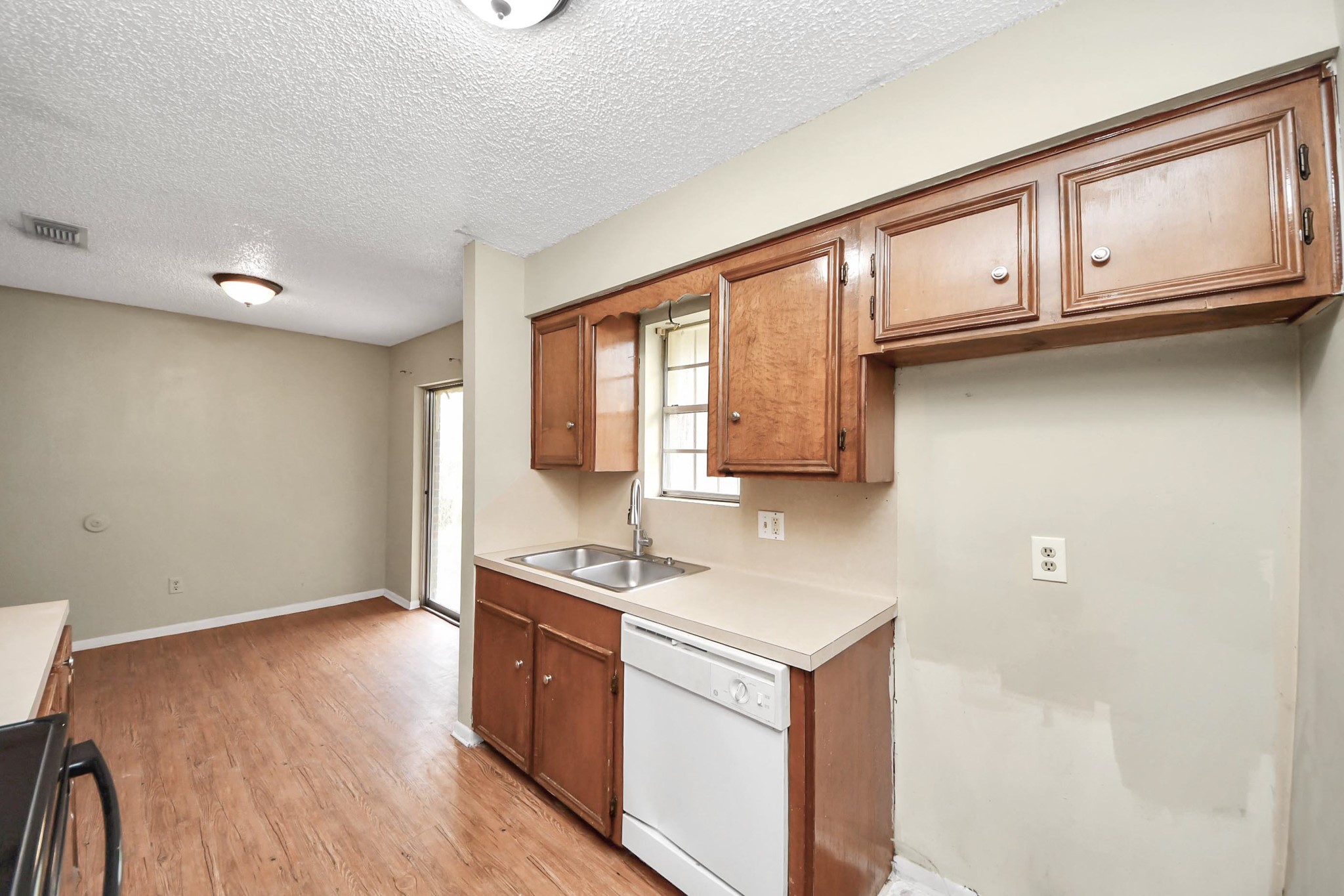 1006 Perry Street, Unit 100 Cleveland, TX 77327 - Photo 21 of 38 a kitchen with stainless steel appliances granite countertop a stove a sink and a microwave oven with white cabinets