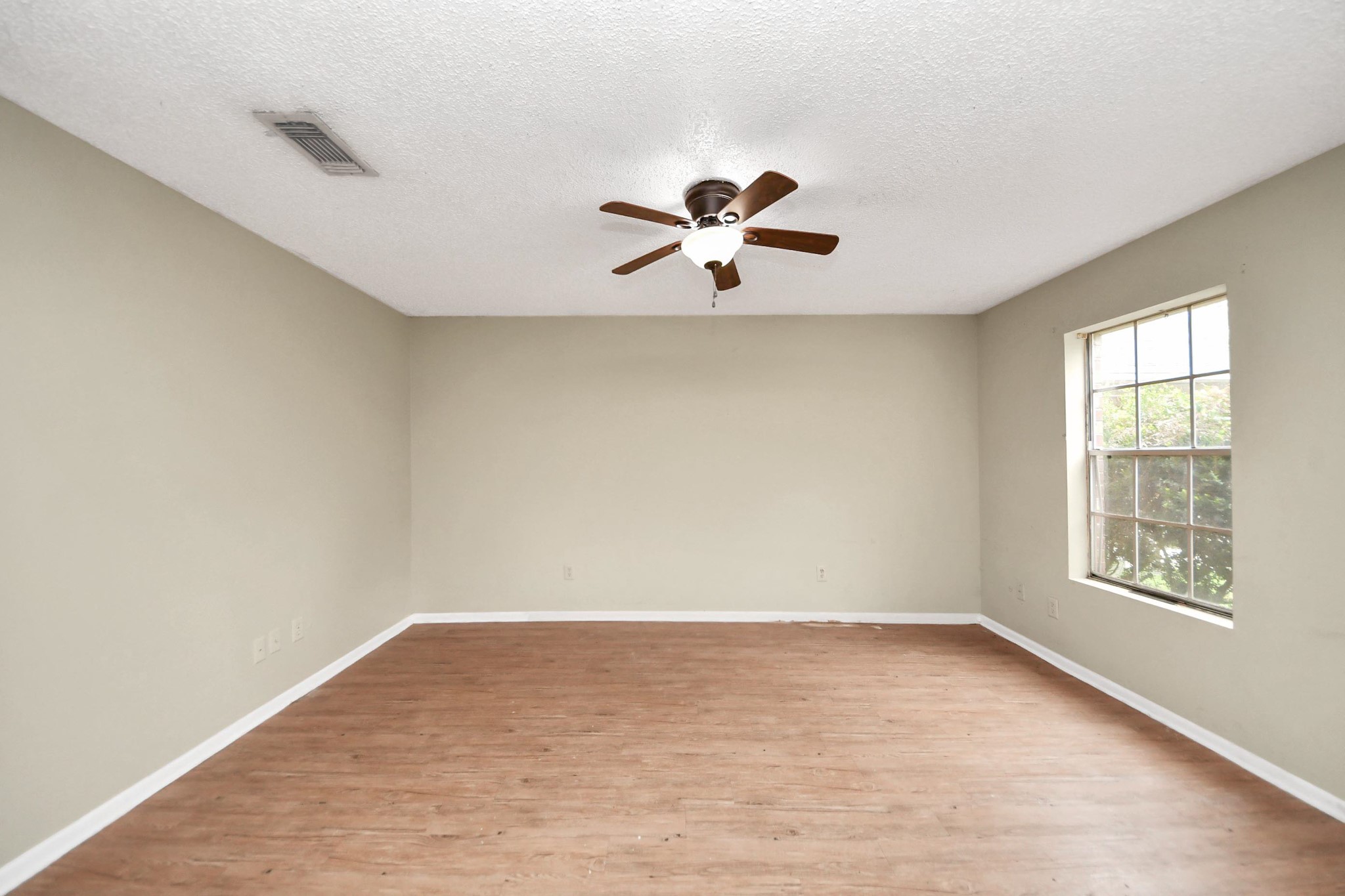1006 Perry Street, Unit 100 Cleveland, TX 77327 - Photo 26 of 38 wooden floor in an empty room with a window