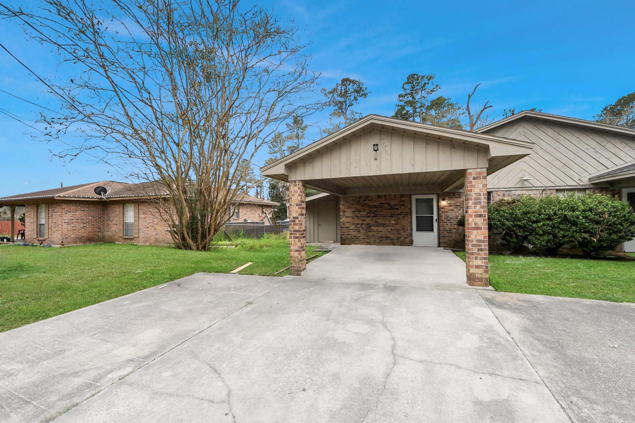 1006 Perry Street, Unit 100 Cleveland, TX 77327 - Photo 3 of 38 a front view of a house with a yard and garage