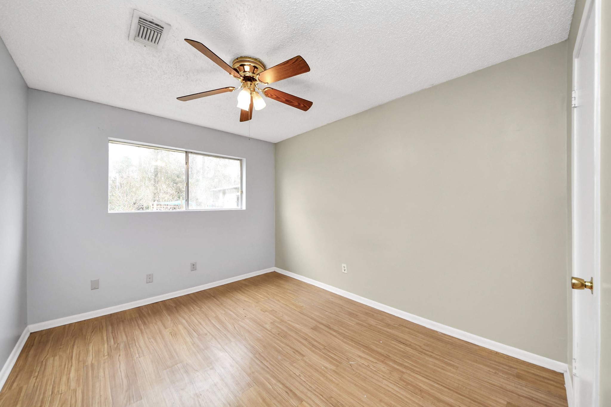 1006 Perry Street, Unit 100 Cleveland, TX 77327 - Photo 33 of 38 wooden floor in an empty room with a window