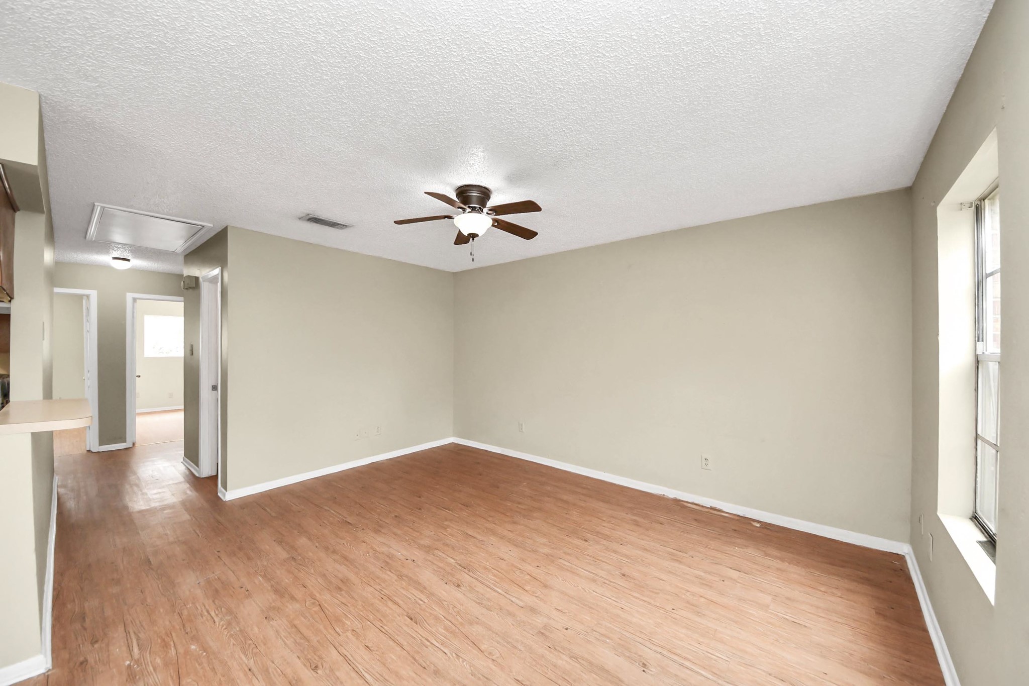 1006 Perry Street, Unit 100 Cleveland, TX 77327 - Photo 9 of 38 wooden floor in an empty room with a window