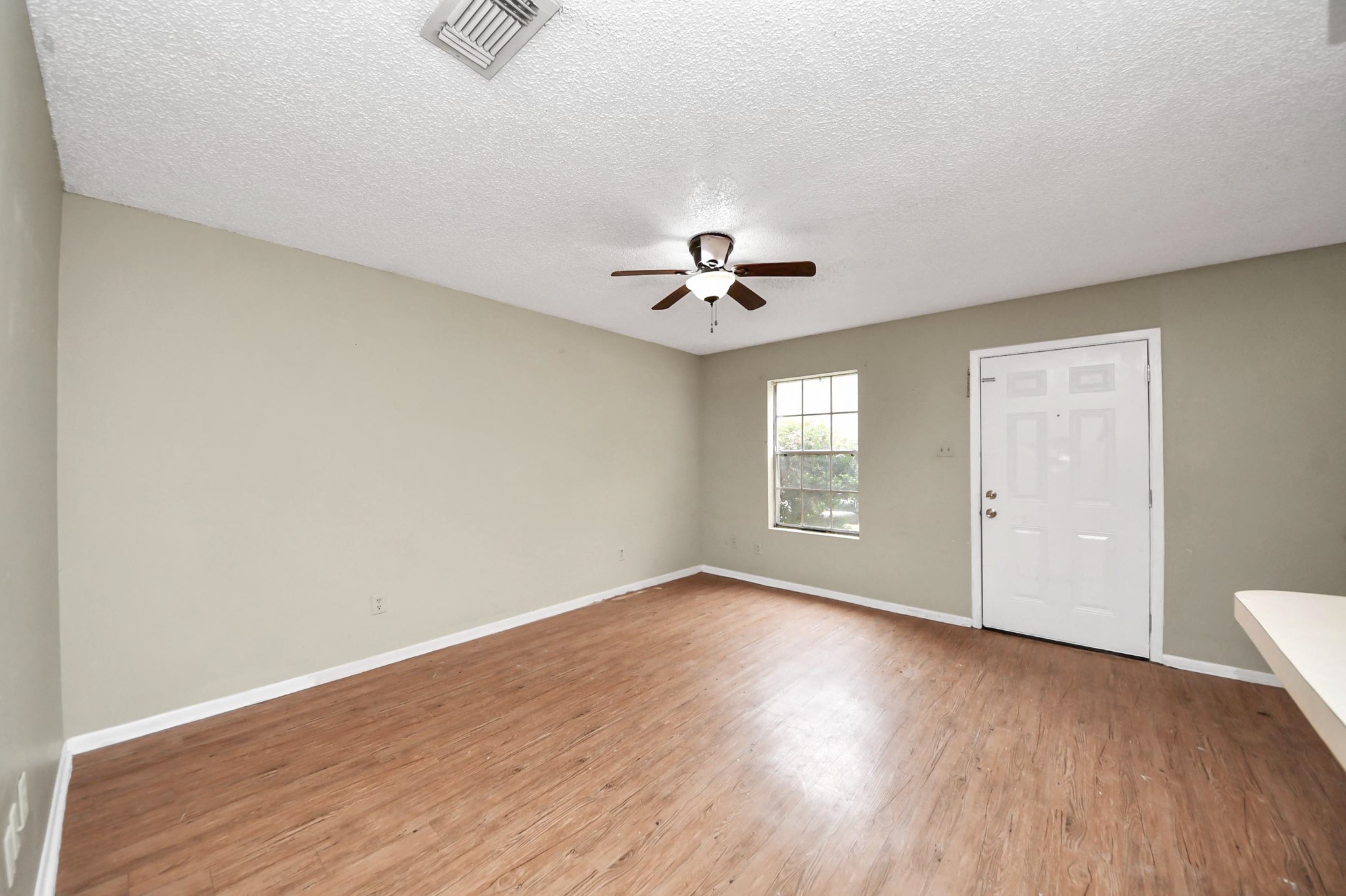 1006 Perry Street, Unit 100 Cleveland, TX 77327 - Photo 10 of 38 wooden floor in an empty room with a window