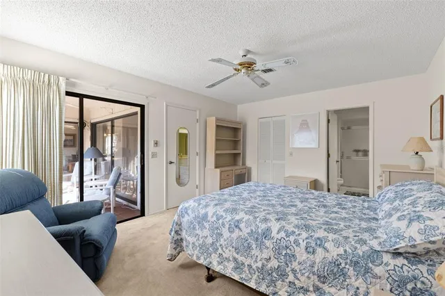 a bedroom with a large bed couch and a window