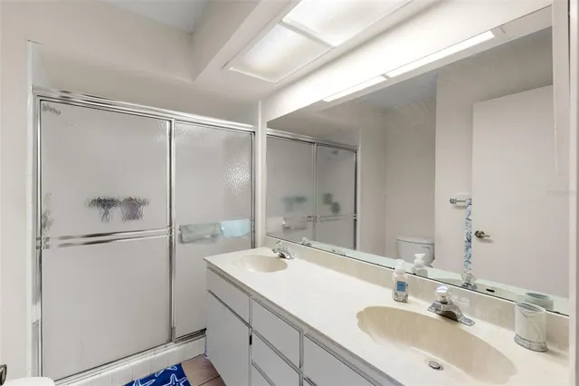 a bathroom with a shower sink and mirror