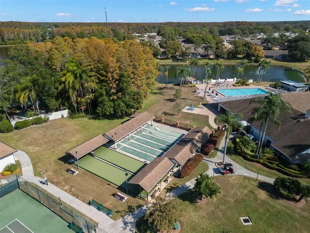 an aerial view of a house with a lake