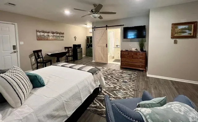 a bedroom with a bed and a flat screen tv