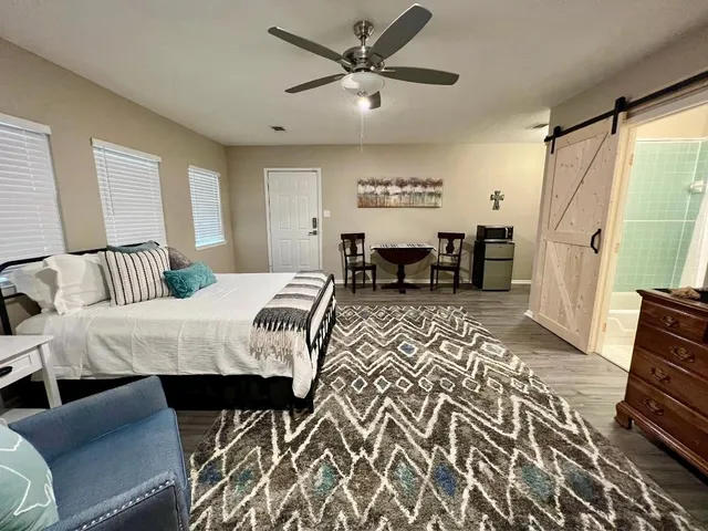 a bed room with a bed and a chair