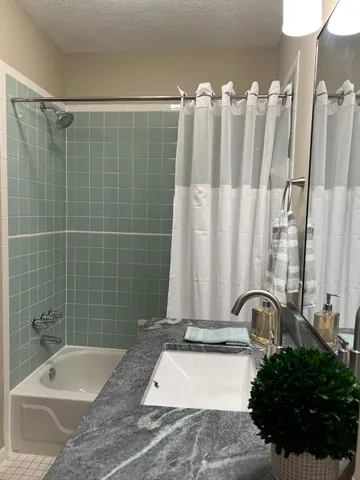 a bathroom with a bathtub a sink and a shower