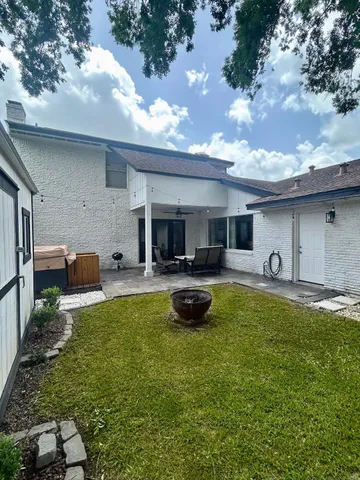 a view of a house with swimming pool and a garden