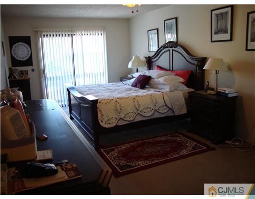 476 Westgate Drive Edison, NJ 08820 - Photo 7 of 10 a bed sitting in a bedroom next to a window