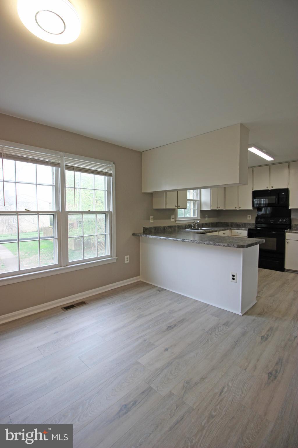 8022 Northumberland Road Springfield, VA 22153 - Photo 12 of 42 a kitchen with stainless steel appliances granite countertop a stove a sink and a microwave