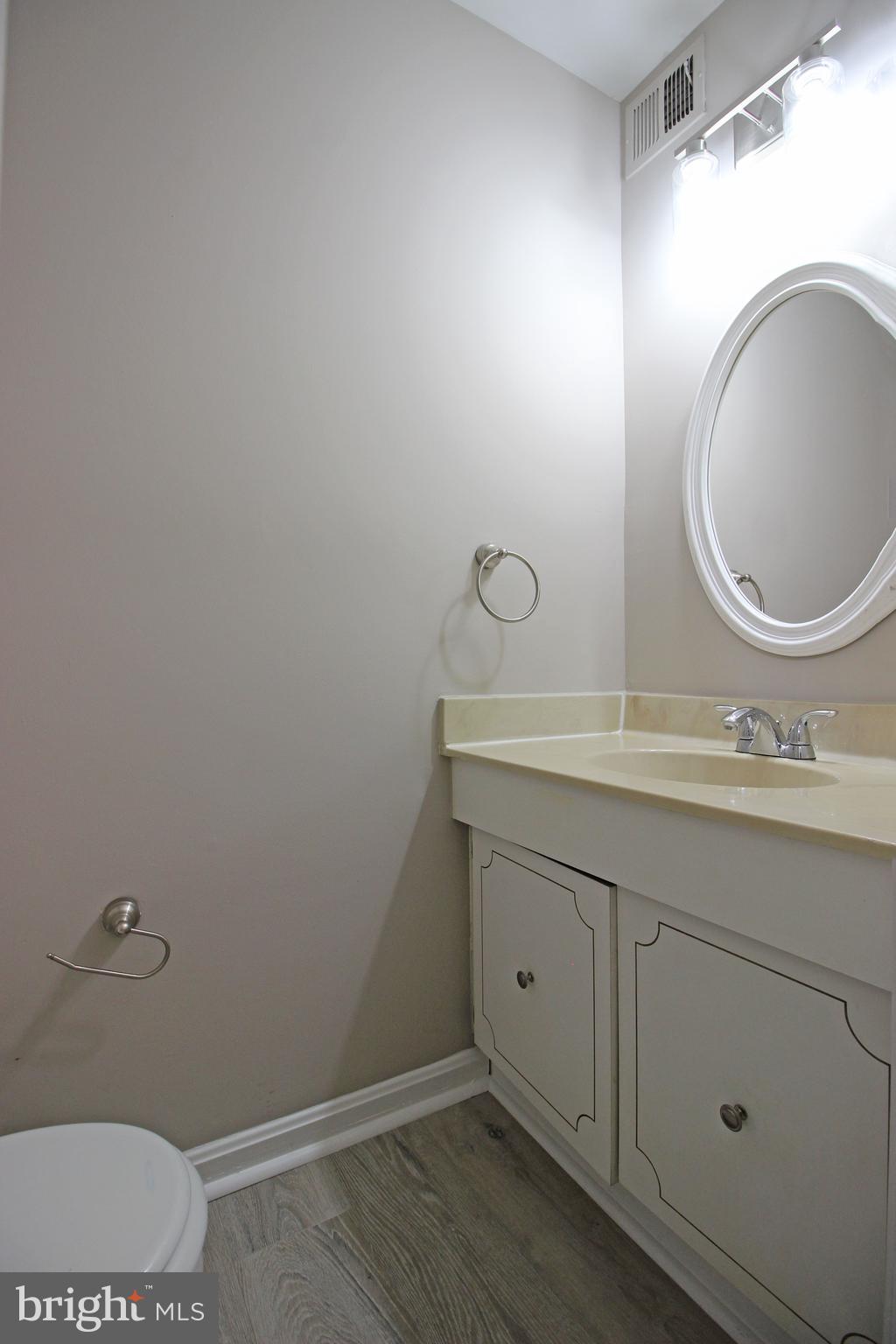 8022 Northumberland Road Springfield, VA 22153 - Photo 37 of 42 a bathroom with a toilet sink and mirror