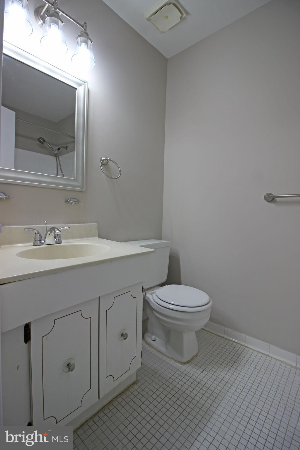 8022 Northumberland Road Springfield, VA 22153 - Photo 40 of 42 a bathroom with a toilet a sink a vanity and mirror