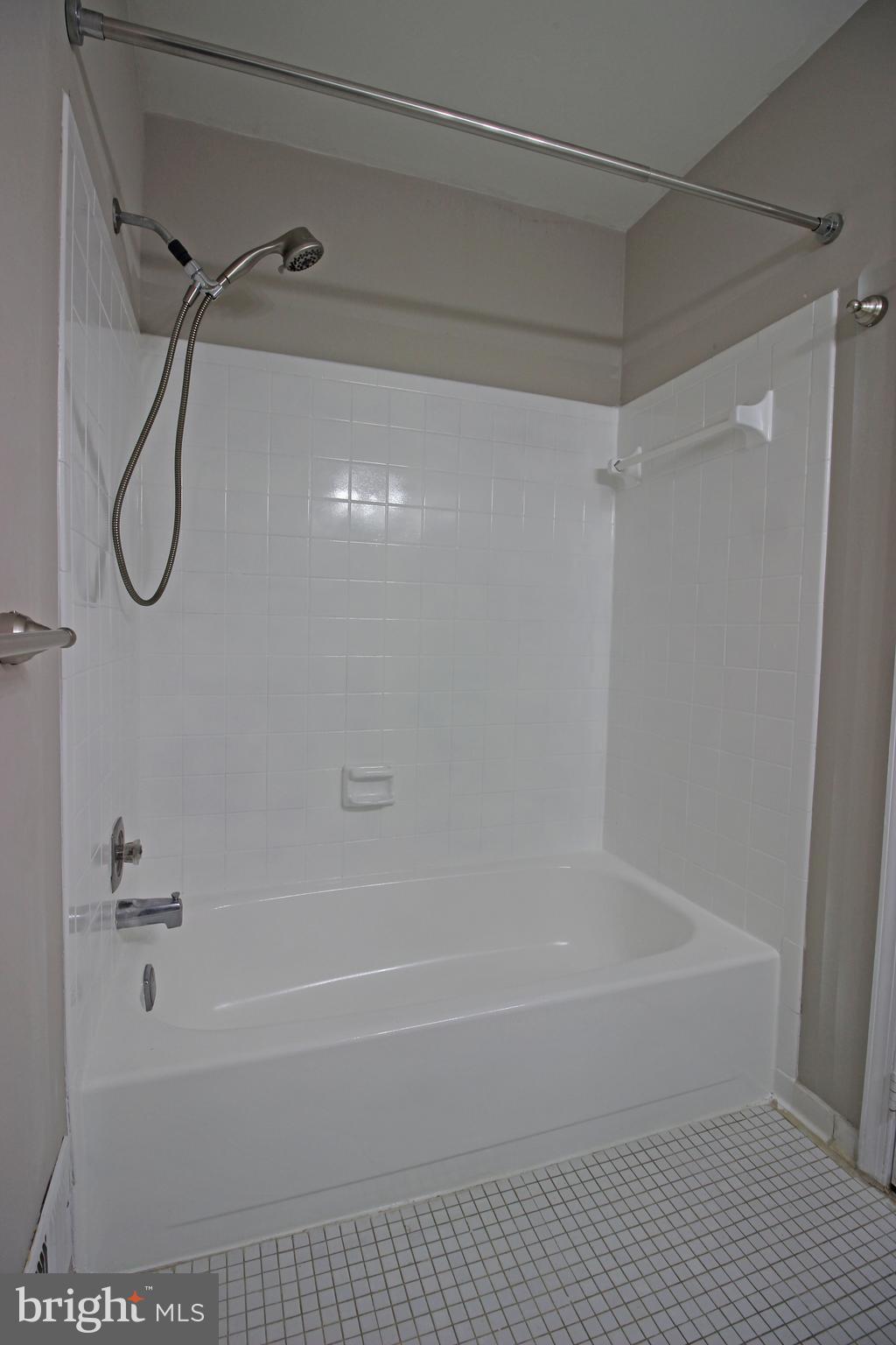 8022 Northumberland Road Springfield, VA 22153 - Photo 41 of 42 a bathroom with a shower and a bath tub