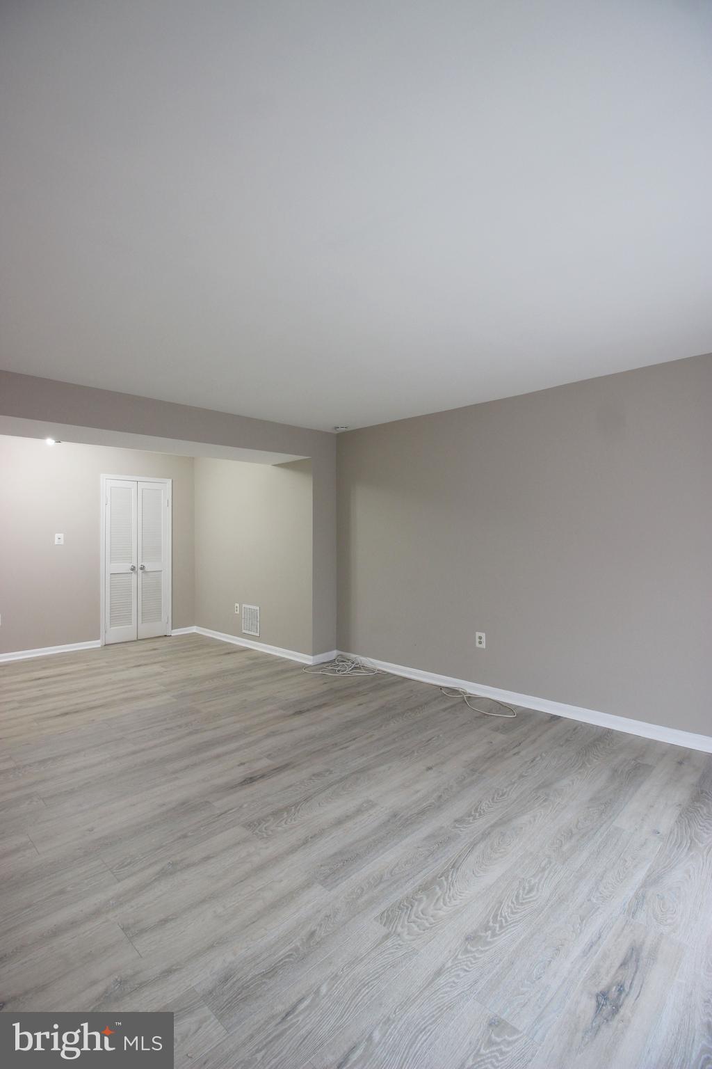 8022 Northumberland Road Springfield, VA 22153 - Photo 5 of 42 a view of an empty room with wooden floor and closet
