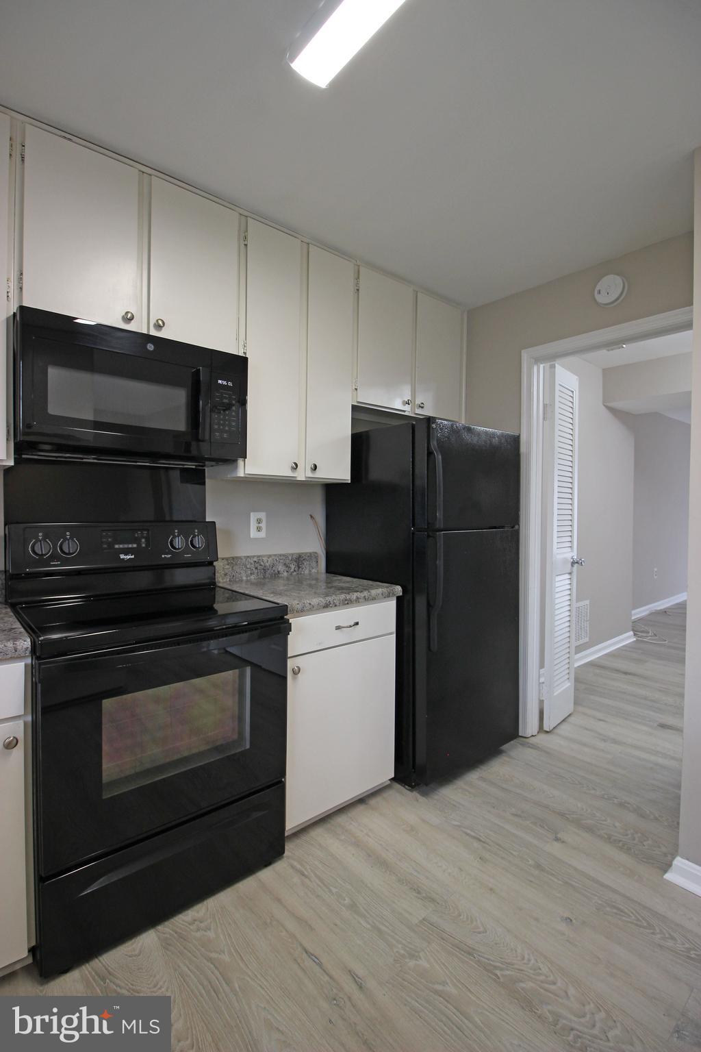 8022 Northumberland Road Springfield, VA 22153 - Photo 8 of 42 a kitchen with a refrigerator stove and cabinets
