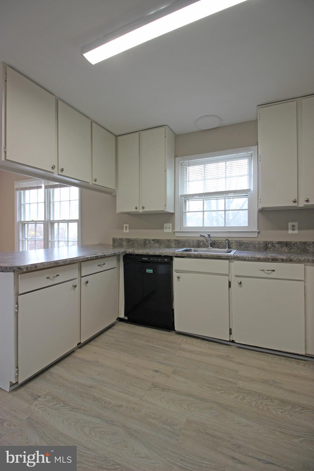 8022 Northumberland Road Springfield, VA 22153 - Photo 9 of 42 a kitchen with granite countertop white cabinets and white appliances