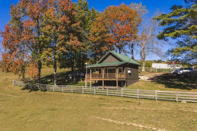 a view of a house with a large tree