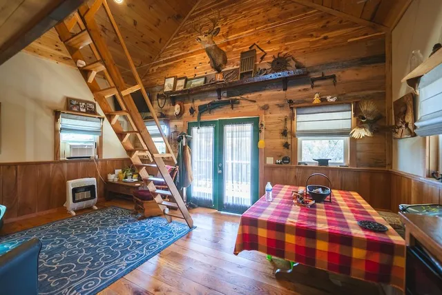 a spacious bedroom with a bed and wooden floor