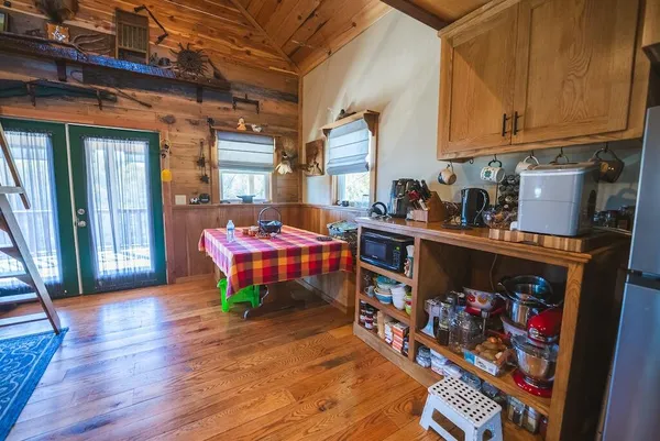 a room with wooden furniture and large windows