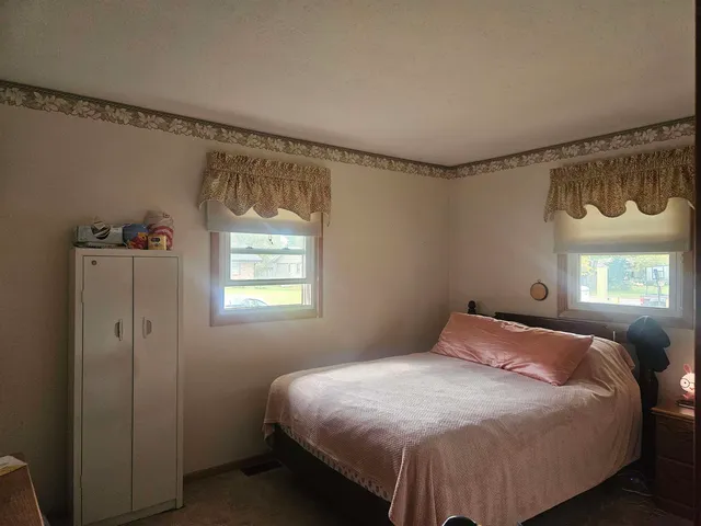 a bedroom with a bed and window