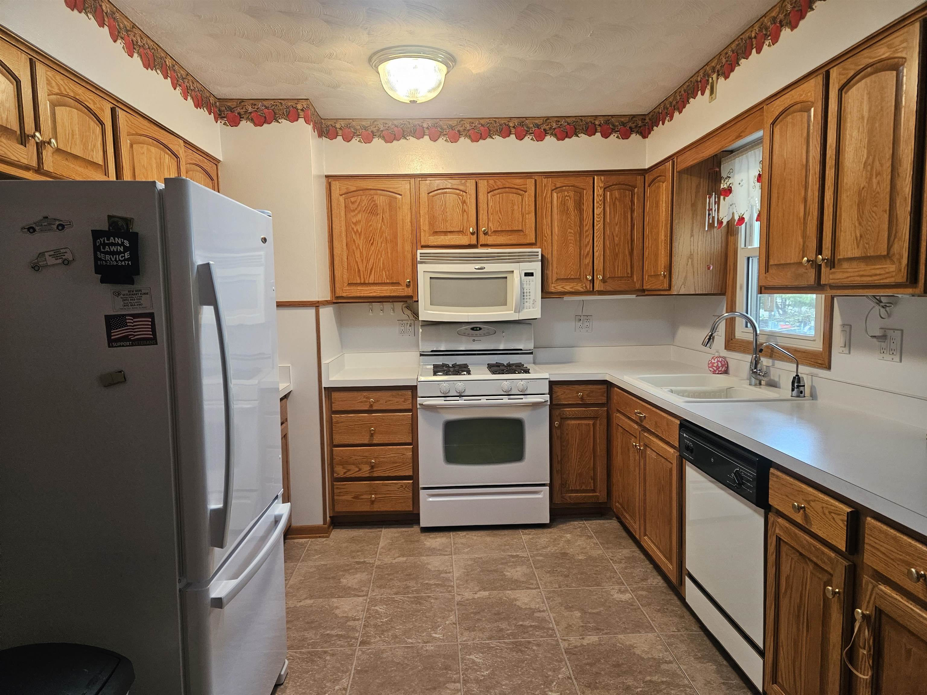 232 East 10th Street Pecatonica, IL 61063 - Photo 12 of 15 a kitchen with stainless steel appliances a refrigerator sink and stove