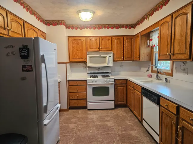 a kitchen with stainless steel appliances a refrigerator sink and stove